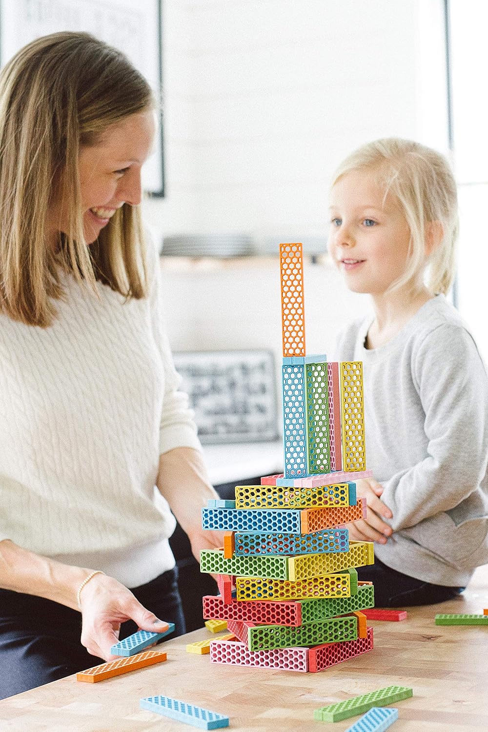 An adult and a child building together with Perfect Blocks