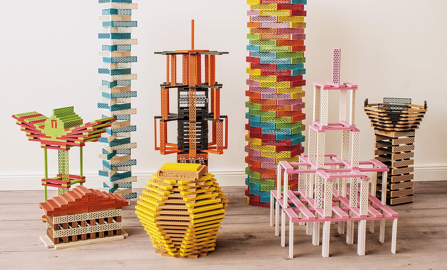 Towers, bridges and figures built from colorful Perfect Blocks honeycomb blocks