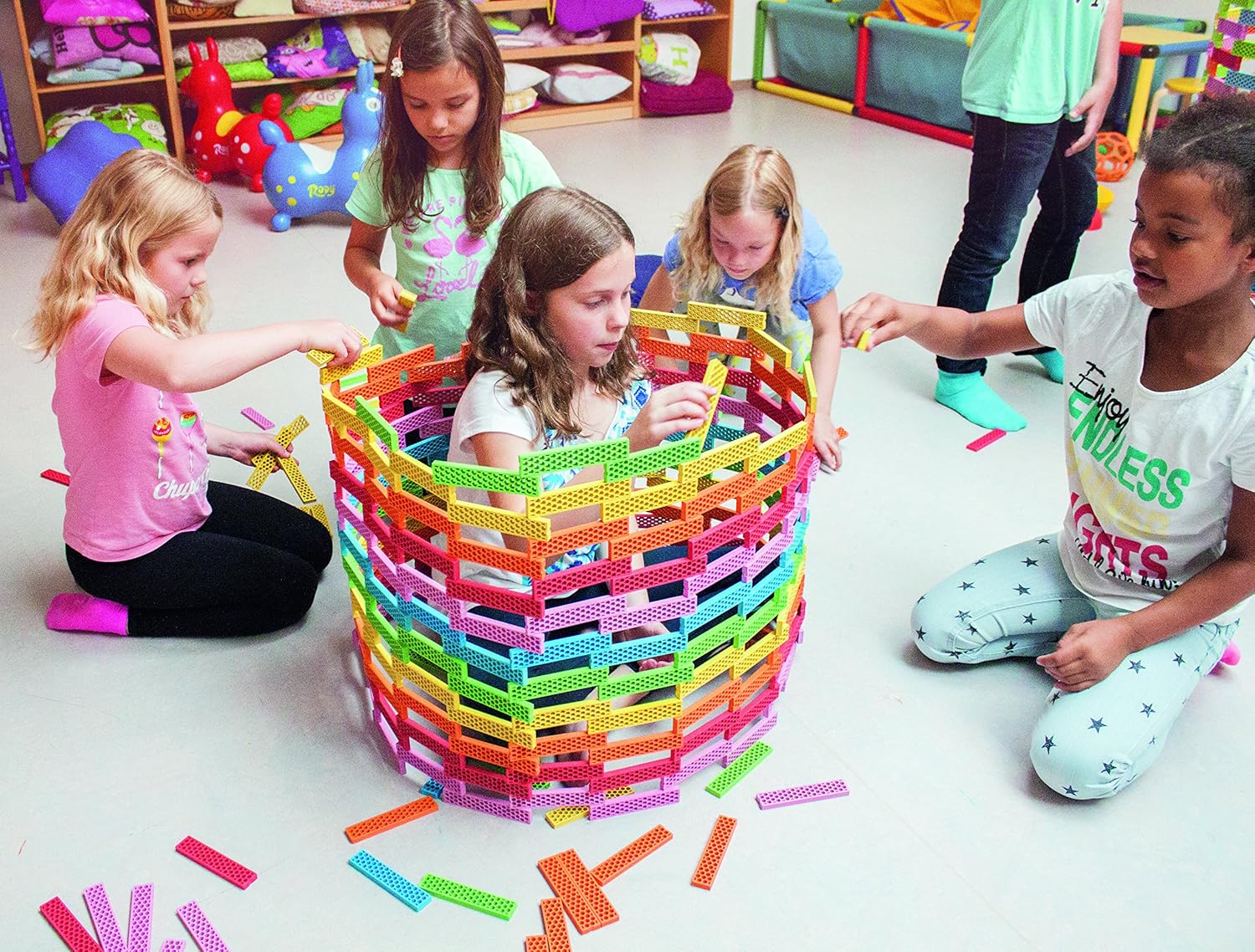 Children building a large round tower together with Perfect Blocks
